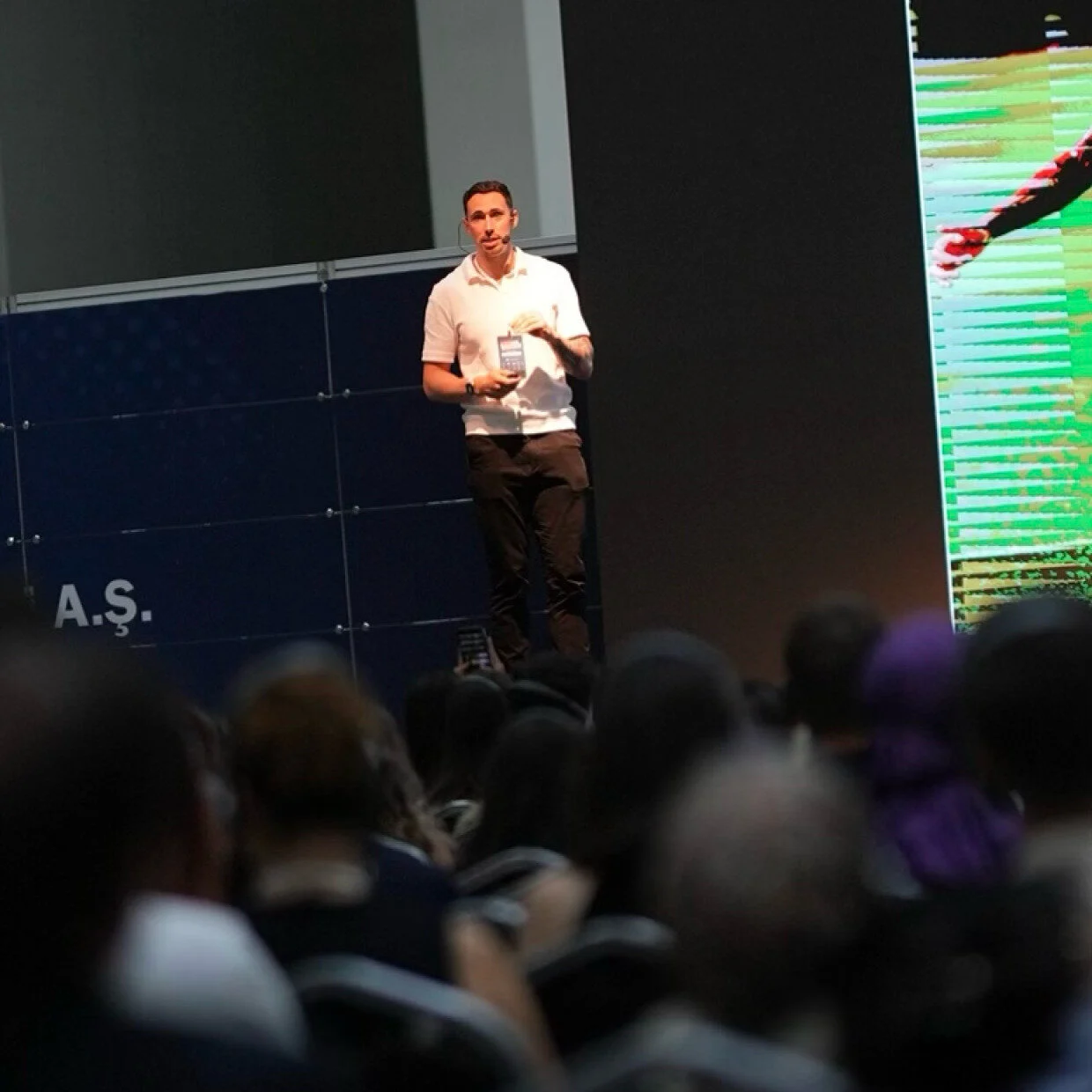 Nessan Presenting on stage